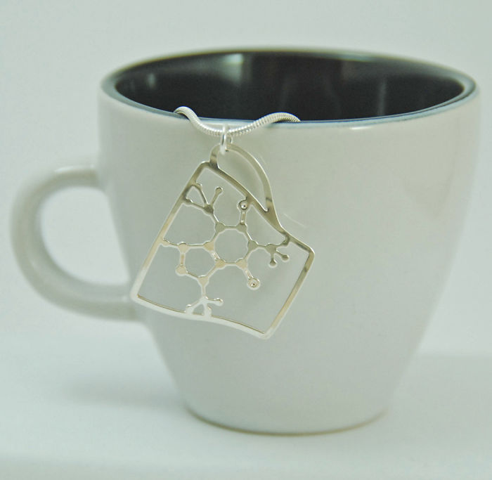 Ciondolo con la molevola della caffeina in una tazza